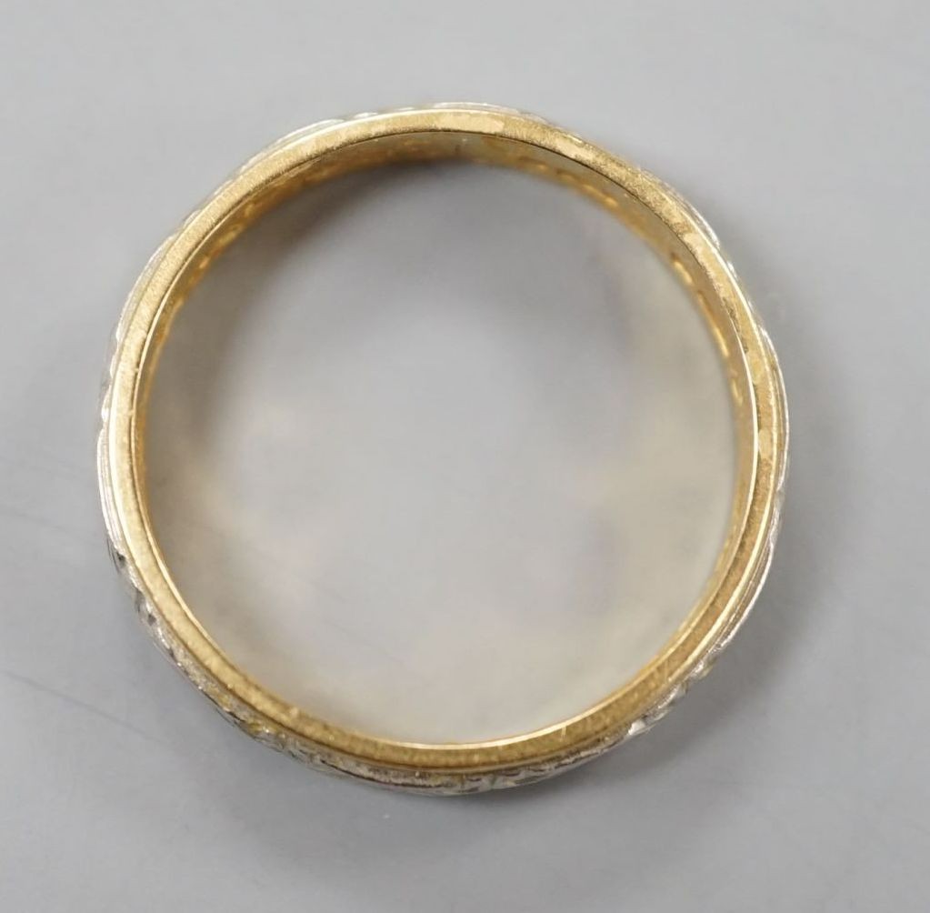 A modern 18ct two colour gold band, size L